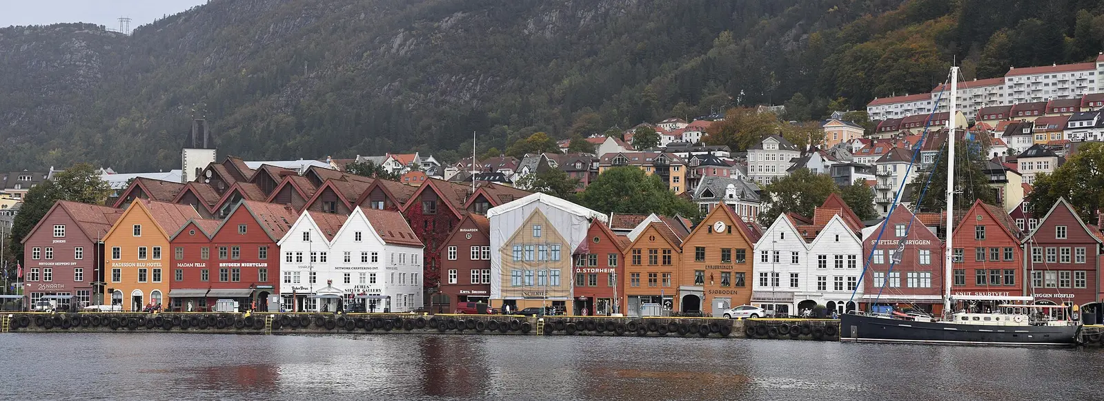 Panorama of the Bryggen wharf in Bergen photographed in 2022, showing moored yachts