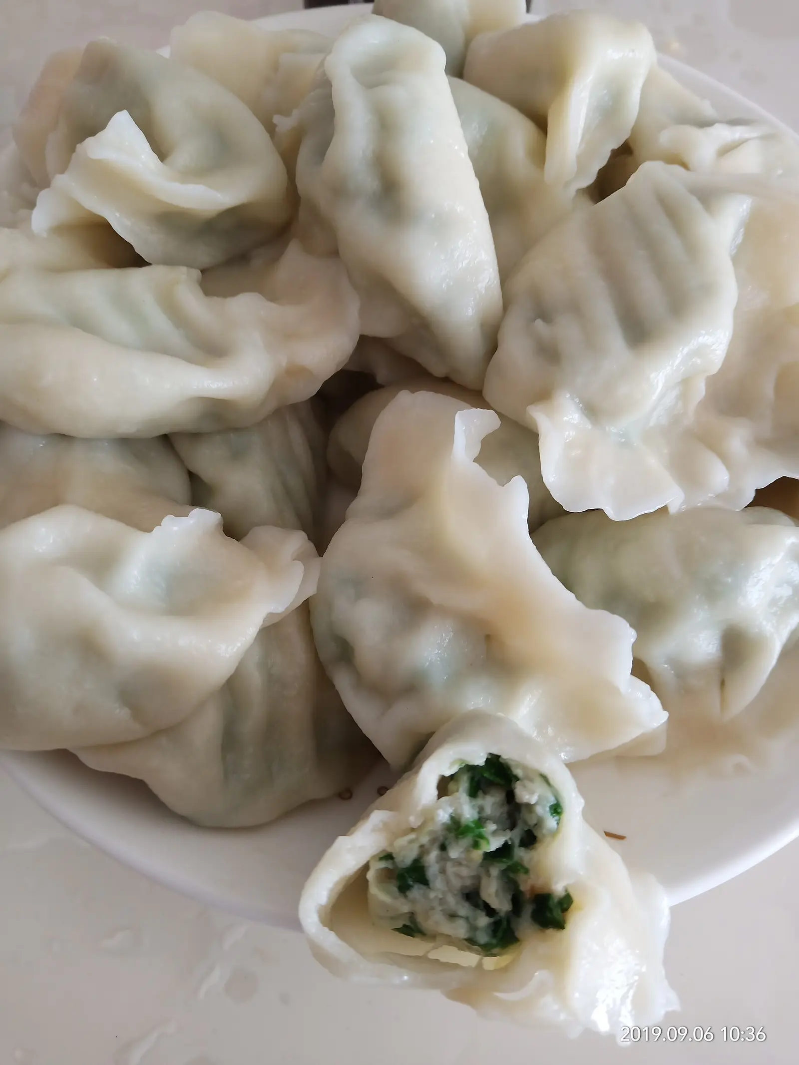 Spanish mackerel dumplings wrapped and boiled at home (the photographer describes them as a home-style dish of the Bohai and Yellow Sea coasts; location not stated)