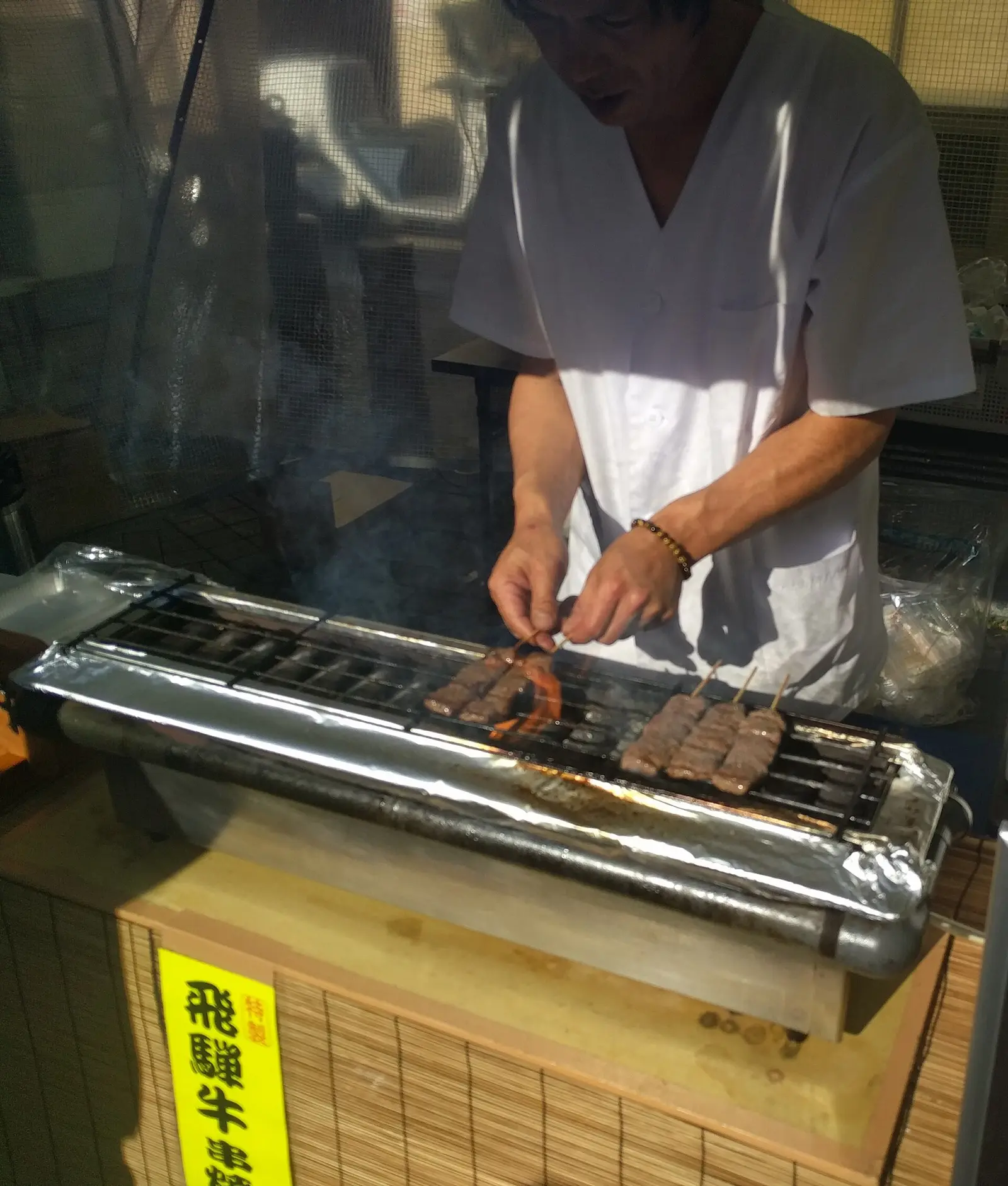 A Takayama street stall grilling Hida beef