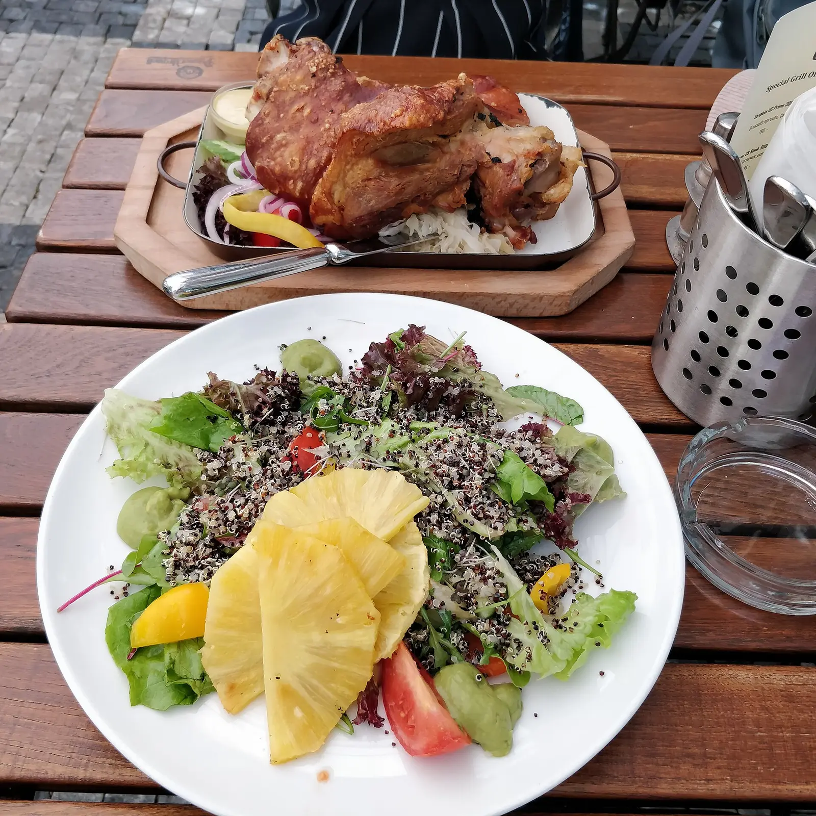 Czech roast pork knuckle with salad at a restaurant in Prague