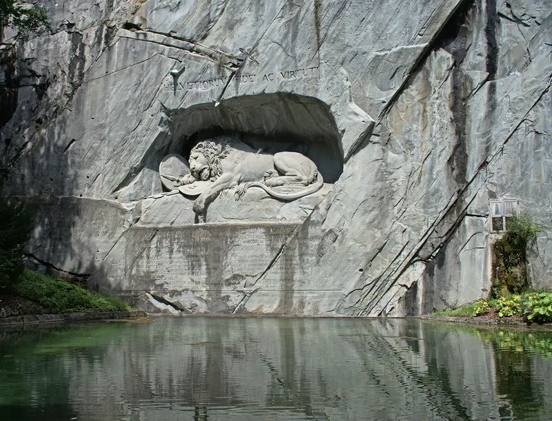 The rock carving and pool of the Lion Monument in Lucerne, photographed in 2020