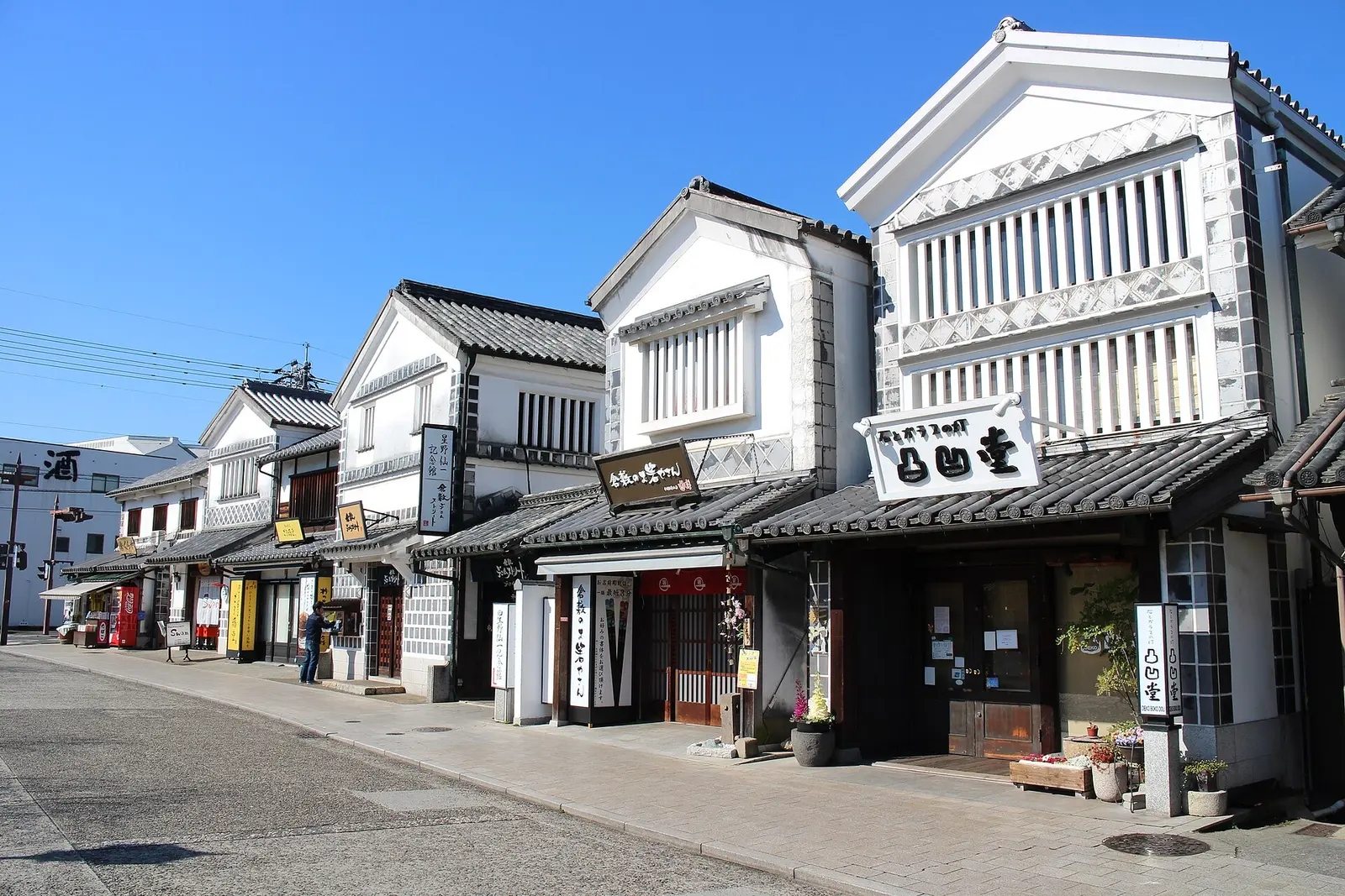 A white-walled street scene in the Kurashiki Bikan Quarter photographed in 2019; it does not represent all areas of Kurashiki City