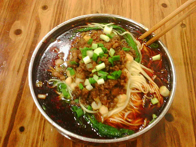 Chongqing's signature snack xiaomian (noodles with peas and minced pork sauce)