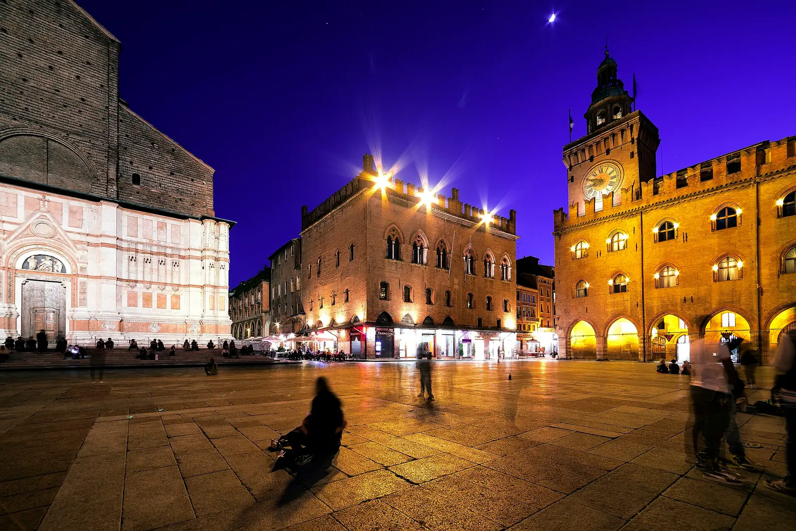 Piazza Maggiore in Bologna at night, photographed in 2018; the photo does not show the Two Towers or the porticoes themselves