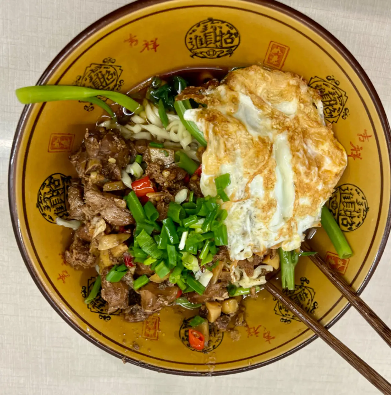 Chongqing xiaomian topped with chili-pepper rabbit (location not specified)